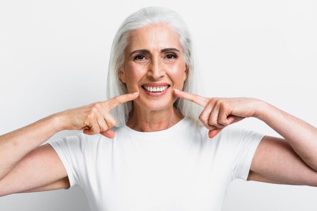 Person eating a walnut, close-up of mouth and hand. Healthy snack concept.