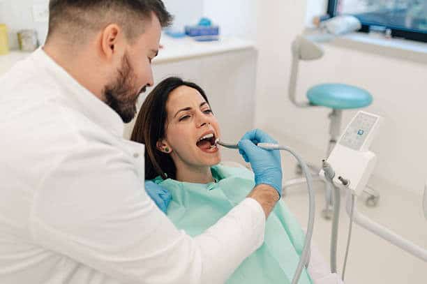 Dentist examining a patient's teeth in a modern dental clinic.
