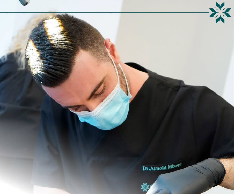 Dentist in mask performing dental procedure with care and precision in a modern clinic setting.