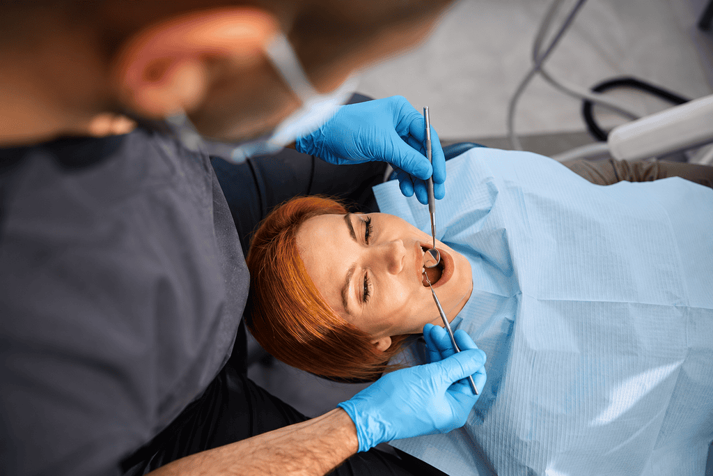 Man using a dental pick revealing bleeding gums, indicating oral health issues or gingivitis concerns.